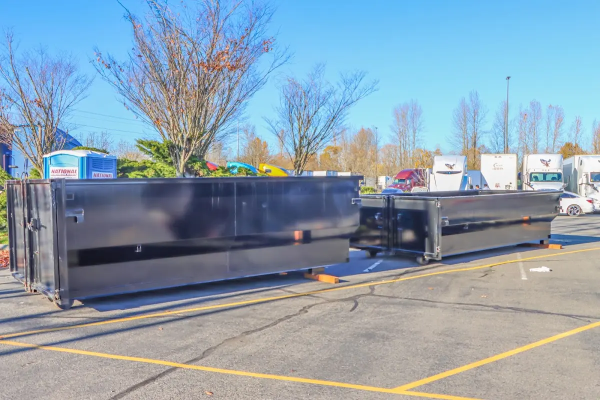 Professional dumpster rental service with roll-off container on residential driveway in Harrisburg